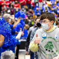 A team member walks past judges after collecting the trophy